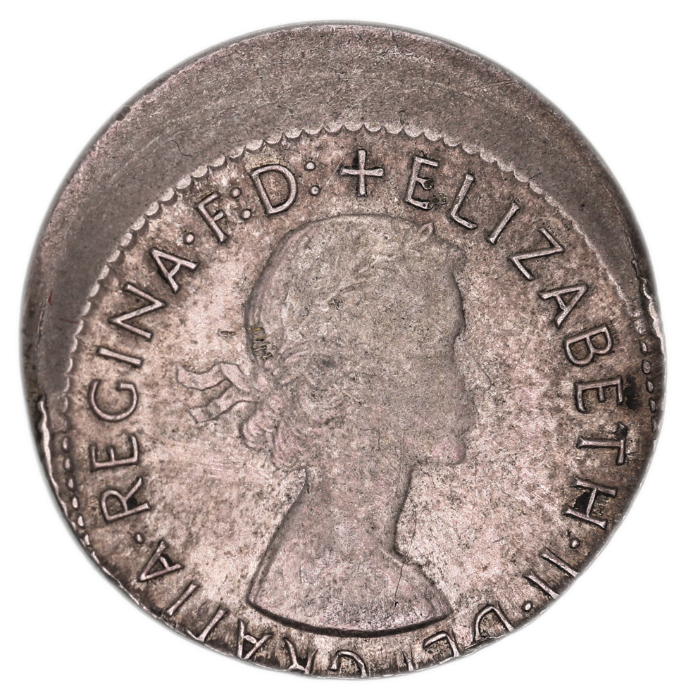 MIS-STRIKES: Elizabeth II, sixpence, 1963, struck off centre by 25 percent, slipped in collar, plain edge.